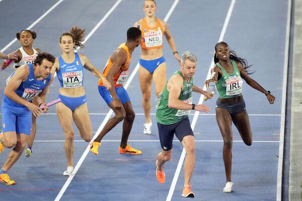 ORANJE CRUSHED: Rhasidat Adeleke, of Ireland, hands the baton to teammate Thomas Barr with Ireland's Dutch rivals left in the distance after the key battle of the race. Pic: AP Photo/Gregorio Borgia