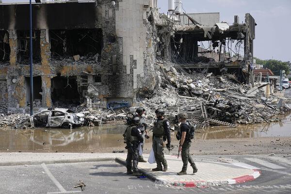 Israeli police retrieve weapons used by militants outside a police station that was overrun by Hamas gunmen on Saturday, in Sderot, Israel, Sunday, Oct.8, 2023. (AP Photo/Ohad Zwigenberg)
