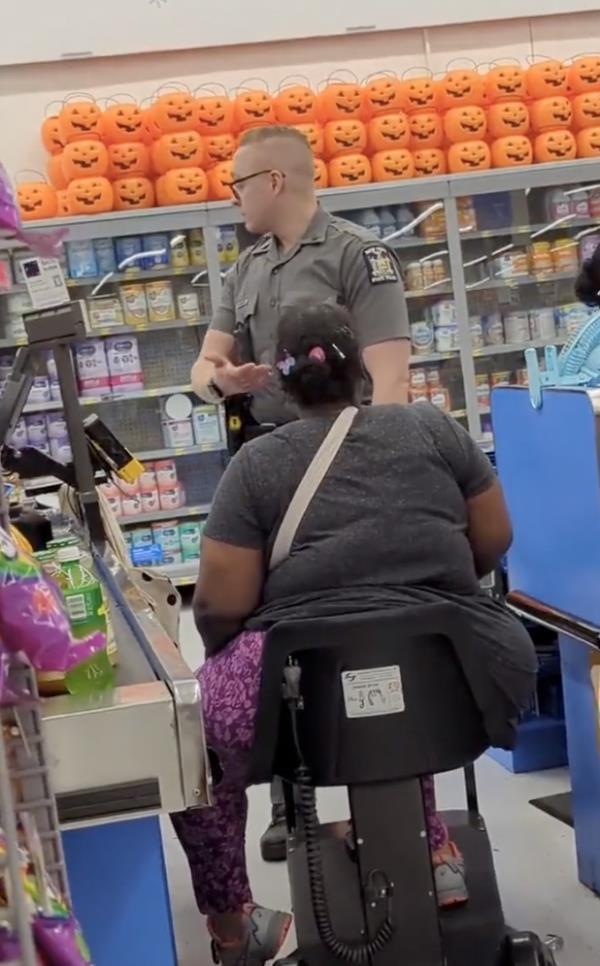 pictured are a woman and a cop in the checkout line. 