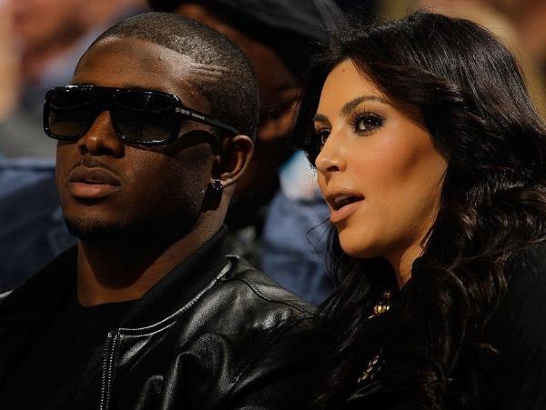 New Orleans Saints player Reggie Bush sits with Kim Kardashian on the court during the game between the San Antonio Spurs and the New Orleans Hornets at New Orleans Arena on January 18, 2010 in New Orleans, Louisiana.