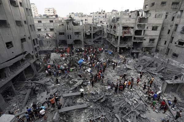 Palestinians inspect the damage after air strikes (Abed Khaled/AP)