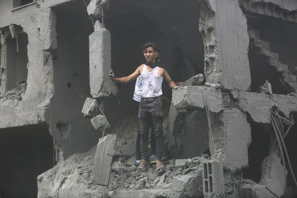 Palestinians inspect the damage of destroyed buildings following Israeli airstrikes on Gaza City, Friday, Oct. 27, 2023. (AP Photo/Abed Khaled)