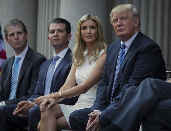 Do<em></em>nald Trump, right, sits with his children, from left, Eric Trump, Do<em></em>nald Trump Jr., and Ivanka Trump during a groundbreaking ceremony for the Trump Internatio<em></em>nal Hotel on July 23, 2014, in Washington. Picture: AP Photo/Evan Vucci, File