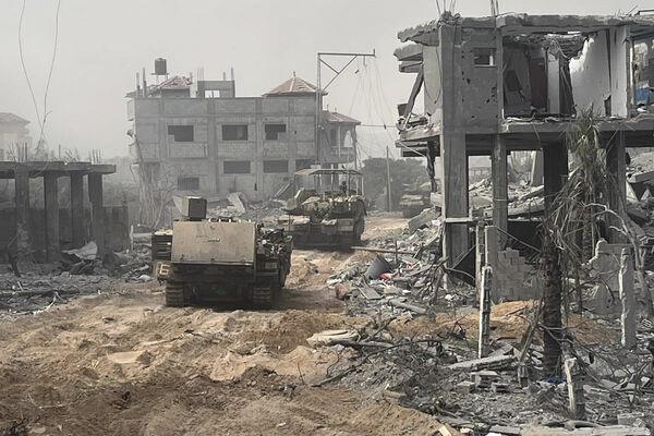In this undated photo provided by the Israeli military, Israeli armored personnel carriers move past destroyed buildings during a ground operation in the Gaza Strip. In this undated photo provided by the Israeli military, Israeli armored personnel carriers move past destroyed buildings during a ground operation in the Gaza Strip.