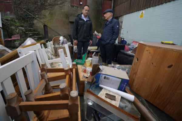 Taoiseach Leo Varadkar observes the damage to a local business on Main Street in Midleton, Picture: Brian Lawless/PA Wire