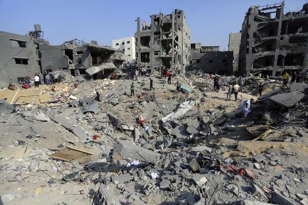 Palestinians wander among debris of buildings that were targeted by Israeli airstrikes in Jabaliya refugee camp, northern Gaza Strip on Wednesday. (Picture: AP Photo/Abed Khaled)