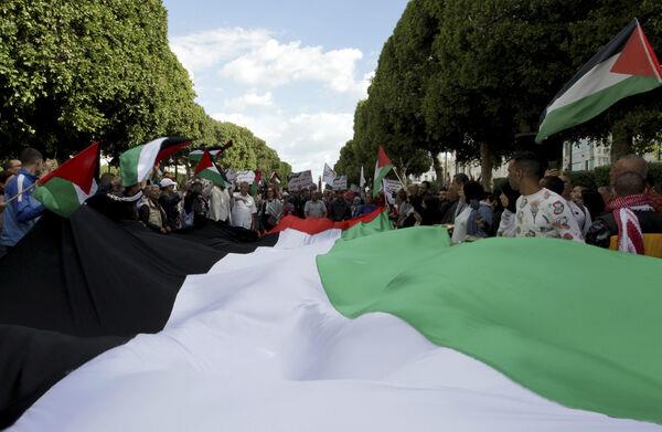 Protesters wave Palestinian flags and shout slogans during a demonstration in solidarity with Gaza, in Tunis, Tunisia. Picture: AP Photo/Hassene Dridi Protesters wave Palestinian flags and shout slogans during a demonstration in solidarity with Gaza, in Tunis, Tunisia. Picture: AP Photo/Hassene Dridi