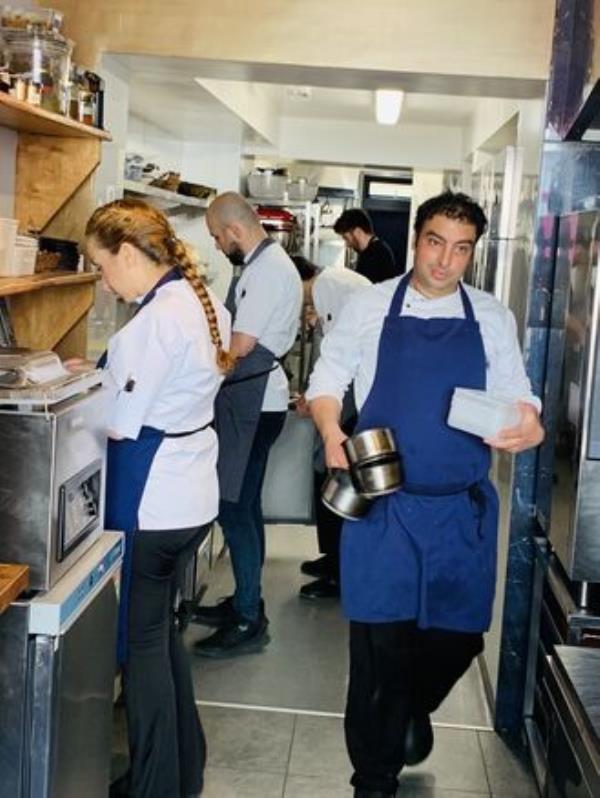 Ahmet Dede oversees an order heading out to tables at Customs House.