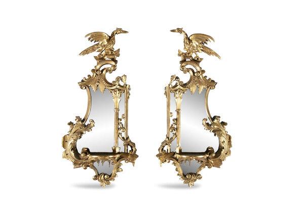  A pair of mirrored wall brackets with ho ho birds at James Adam.