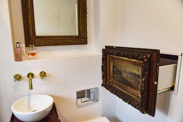  A f<em></em>ramed painting disguises a drawer unit in the bathroom at 132 Ranelagh Road with interior design by David O'Brien. Photograph Moya Nolan