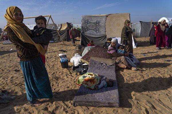 Palestinians displaced by the Israeli bombardment of the Gaza Strip gather at a tent camp, in Rafah, southern Gaza strip. Picture: AP Photo/Fatima Shbair