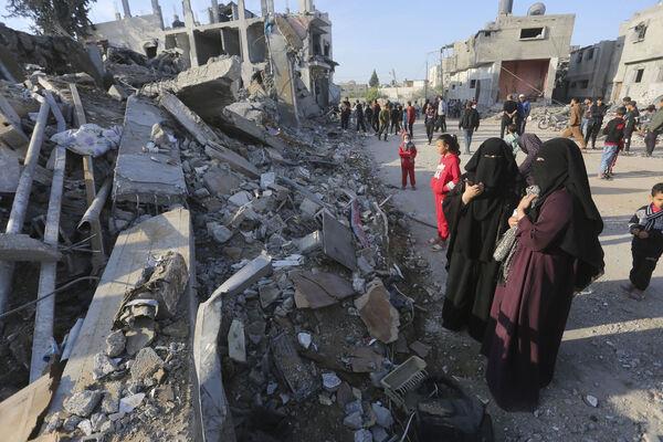 Palestinians look at the destruction by the Israeli bombardment of the Gaza Strip in Rafah. Picture: AP Photo/Hatem Ali