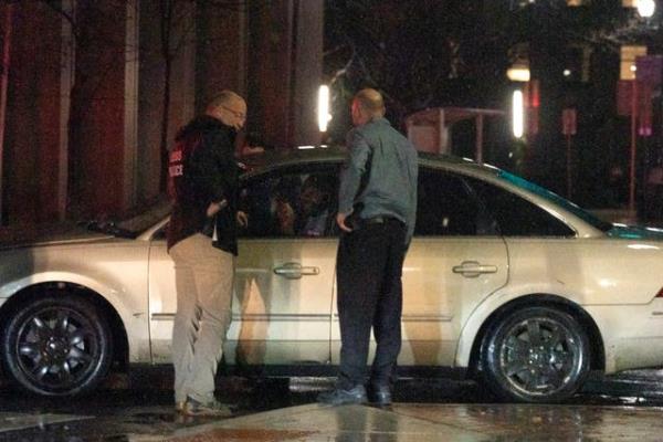 Secret Service Police, left, and security personnel question the driver