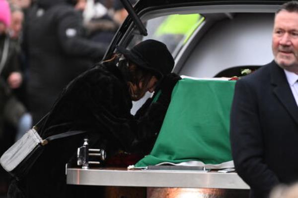 Victoria Mary Clarke pauses by the coffin of her  husband Shane MacGowan. Picture: Larry Cummins