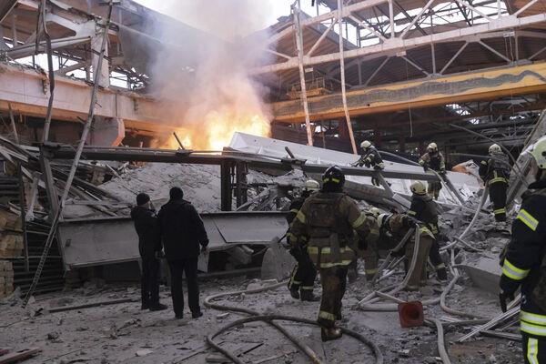 Firefighters work to extinguish a fire after a Russian attack in Kharkiv, Ukraine, Friday, Dec. 29, 2023. (AP Photo/Yevhen Titov)