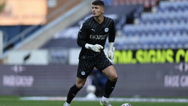 Keeper Sam Tickle looks to distribute.