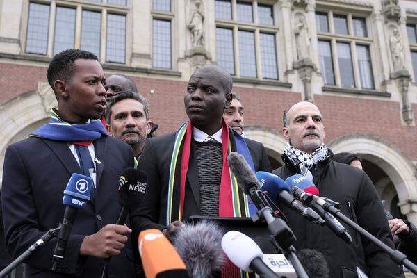 South Africa's Minister of Justice and Correctional Services Ronald Lamola, center, and Palestinian assistant Minister of Multilateral Affairs Ammar Hijazi, right, address the media outside the International Court of Justice in The Hague, Netherlands, Thursday (Picture: AP Photo/Patrick Post) South Africa's Minister of Justice and Correctional Services Ronald Lamola, center, and Palestinian assistant Minister of Multilateral Affairs Ammar Hijazi, right, address the media outside the International Court of Justice in The Hague, Netherlands, Thursday (Picture: AP Photo/Patrick Post)