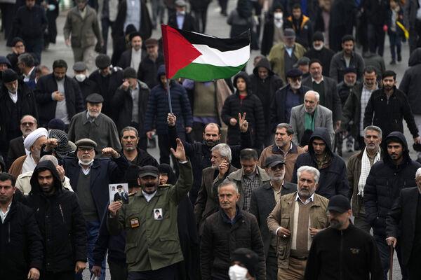 A man holds up a Palestinian flag during a demo<em></em>nstration in which worshippers show their support of Palestinians and co<em></em>ndemning the US and British militaries strike against Iranian-backed Houthis in Yemen, after Friday prayer in Tehran, Iran. Picture: AP Photo/Vahid Salemi