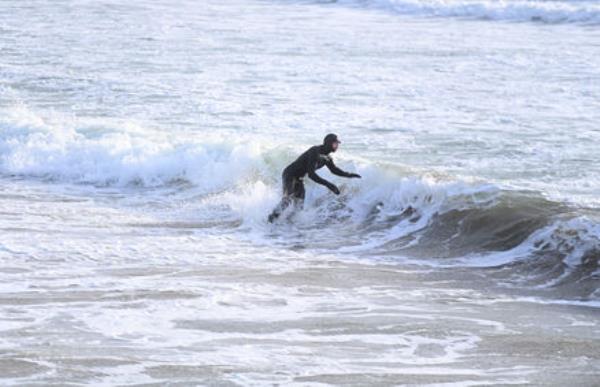  Surfer Cian O'Flynn from Castlelyons catches a wave in the water at Garretstown, Co Cork as the wind and waves begin to rise ahead of the o<em></em>ncoming Storm Isha. Picture: Larry Cummin