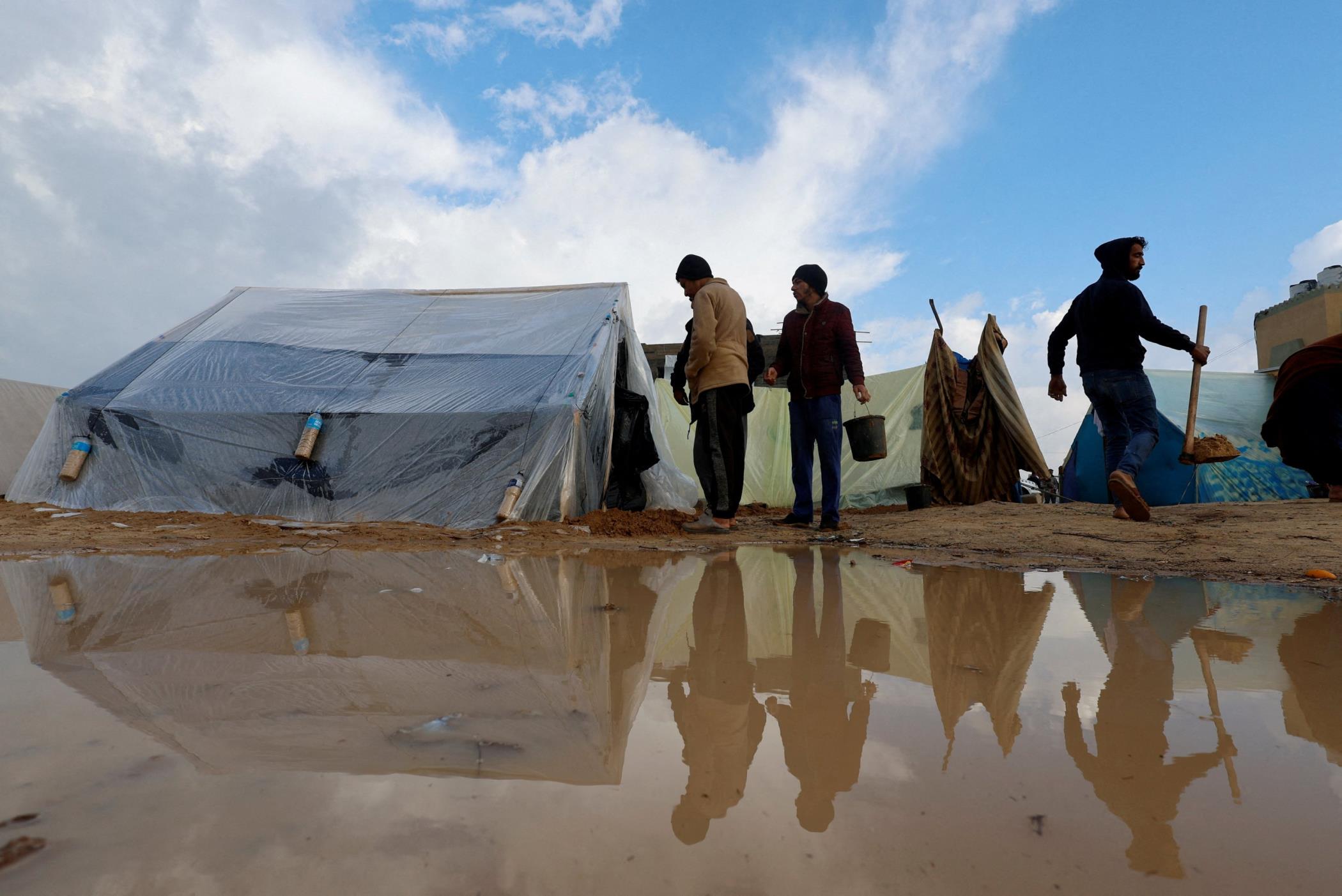 Palestinians children pose in front of their makeshift tent at a camp in Rafah, southern Gaza Strip, Palestine, Dec. 13, 2023. (AFP Photo)