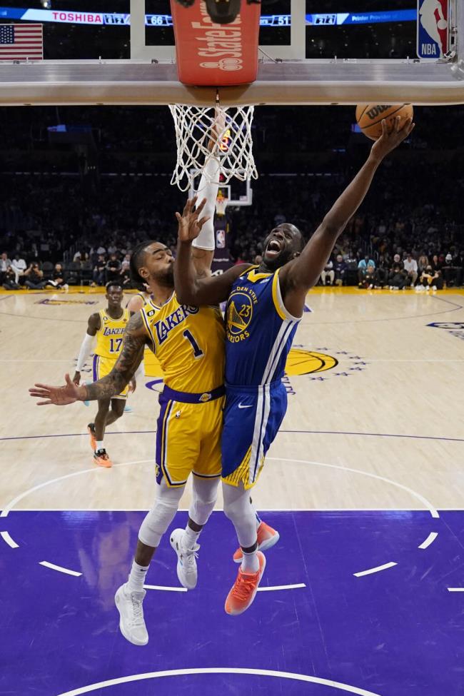 Golden State Warriors forward Draymond Green drives to the basket past Los Angeles Lakers guard D'Angelo Russell during the second half in Game 6 of an NBA basketball Western Co<em></em>nference semifinal series Friday, May 12, 2023, in Los Angeles. (AP Photo/Ashley Landis)