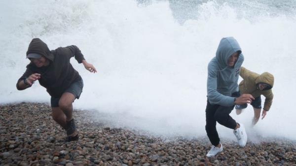 People play amo<em></em>ngst the waves on Chiswell Beach in Dorset, as the Met Office issued a yellow weather warning across the Midlands for thunderstorms and the south of England for strong winds. Picture date: Wednesday August 2, 2023.<em></em>
<em></em>
