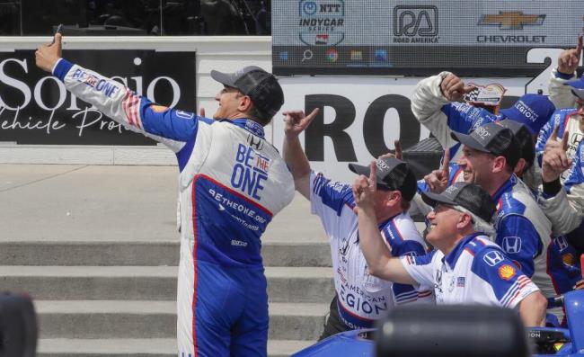 Alex Palou, left, takes a photo with teammates after his victory in an IndyCar auto race, Sunday, June 18, 2023, at Road America near Elkhart Lake, Wis. (Gary C. Klein/The Sheboygan Press via AP)